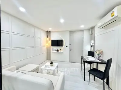 Modern living room with sleek white decor and dining area