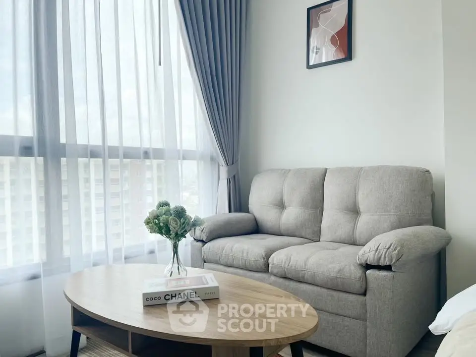 Chic living room with cozy sofa, stylish coffee table, and elegant decor in a bright apartment.