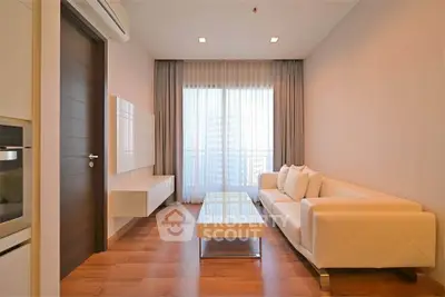 Modern living room with elegant white sofa and floor-to-ceiling windows.