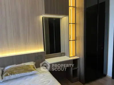 Modern bedroom with sleek design and built-in storage solutions.