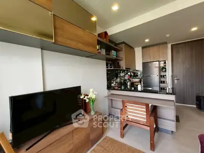 Modern living room with open kitchen, sleek furniture, and stylish decor