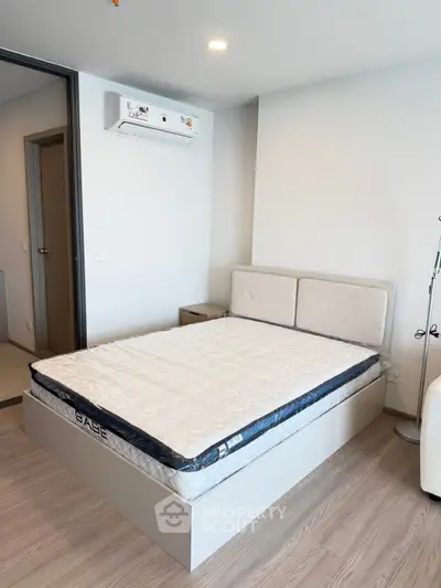 Modern bedroom with sleek design and air conditioning in a stylish apartment.