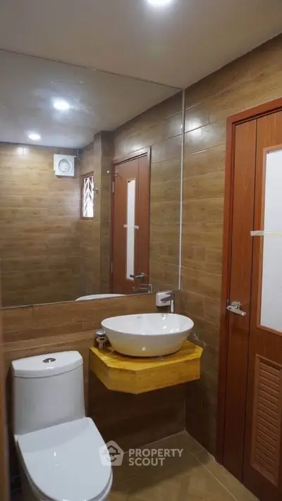Modern bathroom with wooden accents and sleek fixtures
