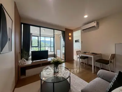 Modern living room with open layout, stylish decor, and natural light in a cozy apartment.