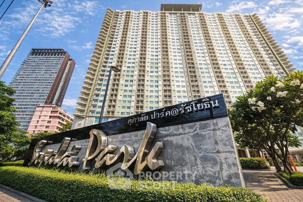 Stunning high-rise condo building with lush landscaping and modern architecture.