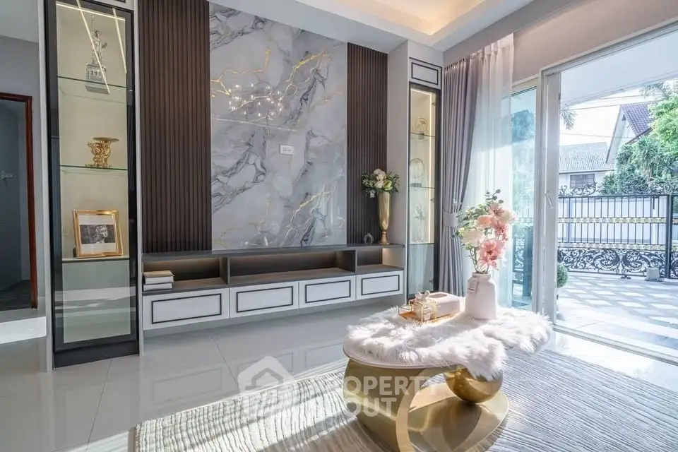 Luxurious living room with elegant decor and large windows opening to a scenic view.