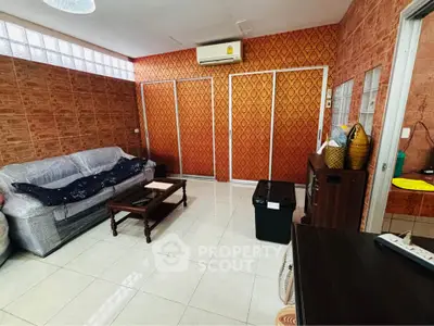 Cozy living room with air conditioning and stylish wallpaper, perfect for relaxation.