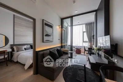 Modern living room with sleek furniture and adjacent bedroom, featuring large windows and stylish decor.