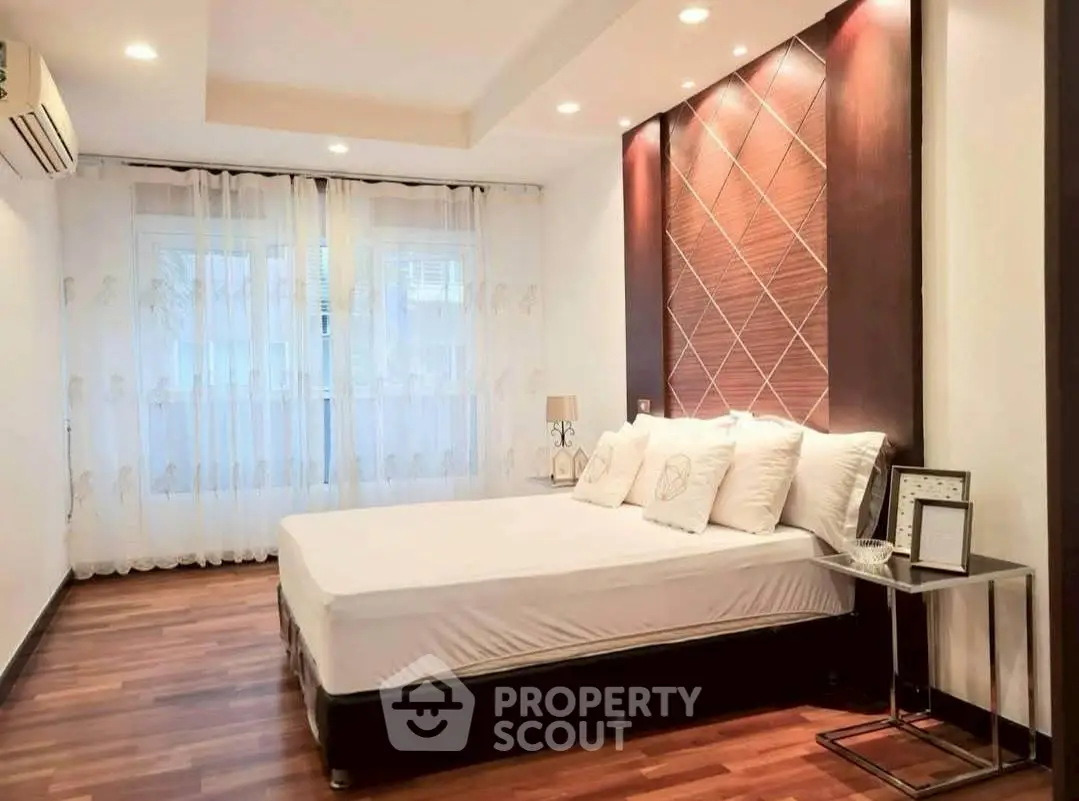 Spacious bedroom with elegant decor and natural light