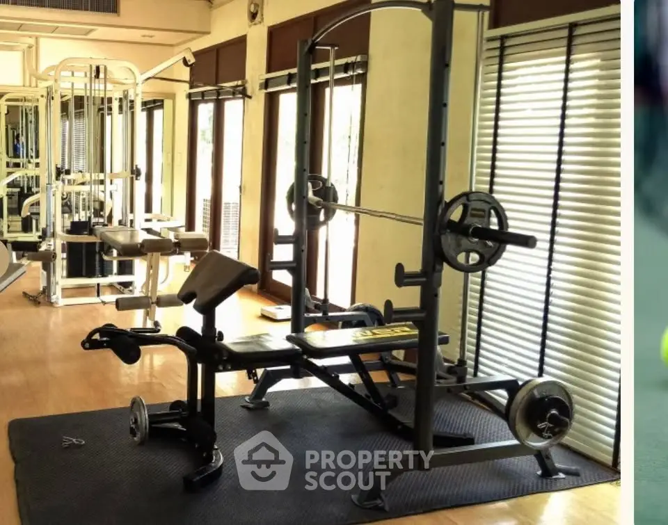 Spacious gym with modern fitness equipment and natural lighting