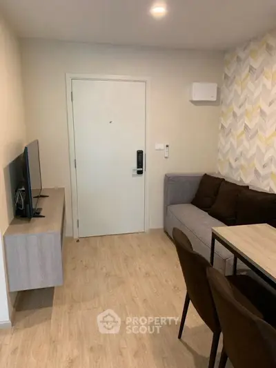 Modern living room with stylish decor and cozy seating area, perfect for relaxation.