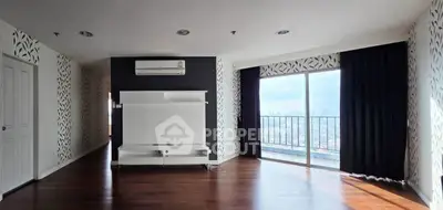 Spacious living room with modern design and city view balcony, perfect for urban living.