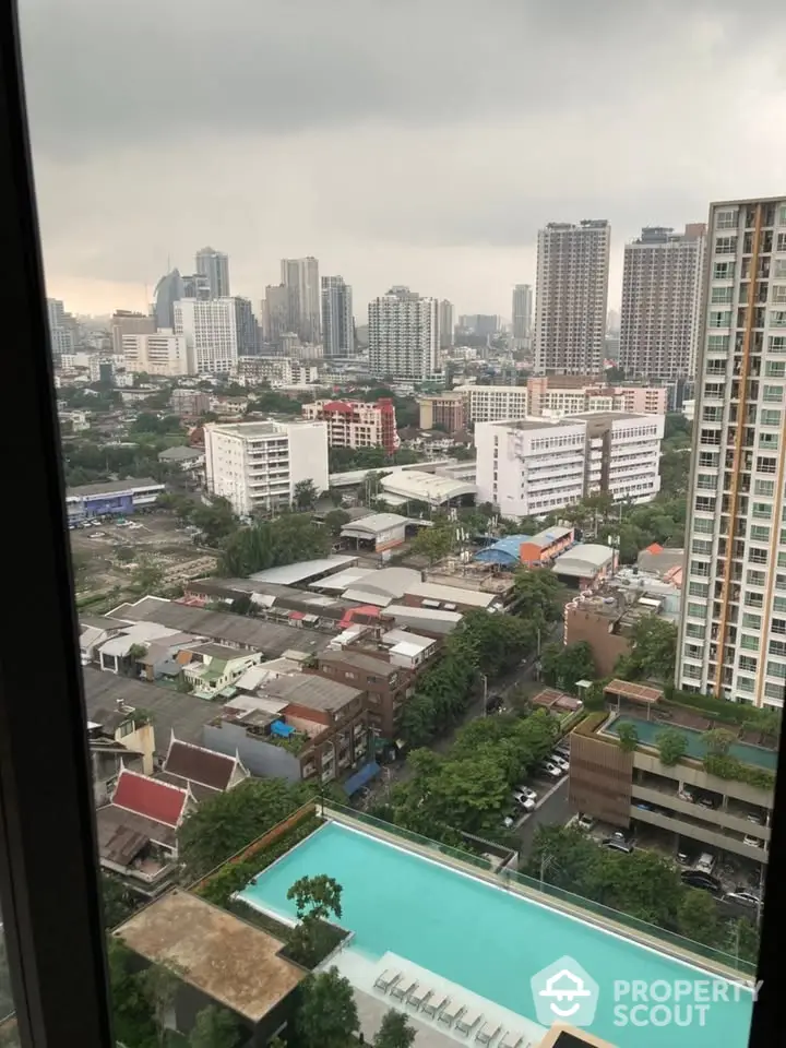 Stunning cityscape view from high-rise apartment with pool