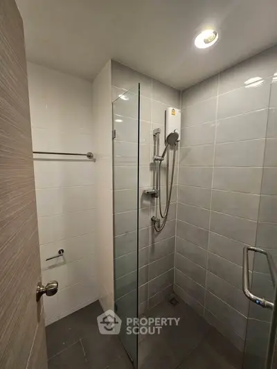 Modern bathroom with glass shower enclosure and sleek tile design