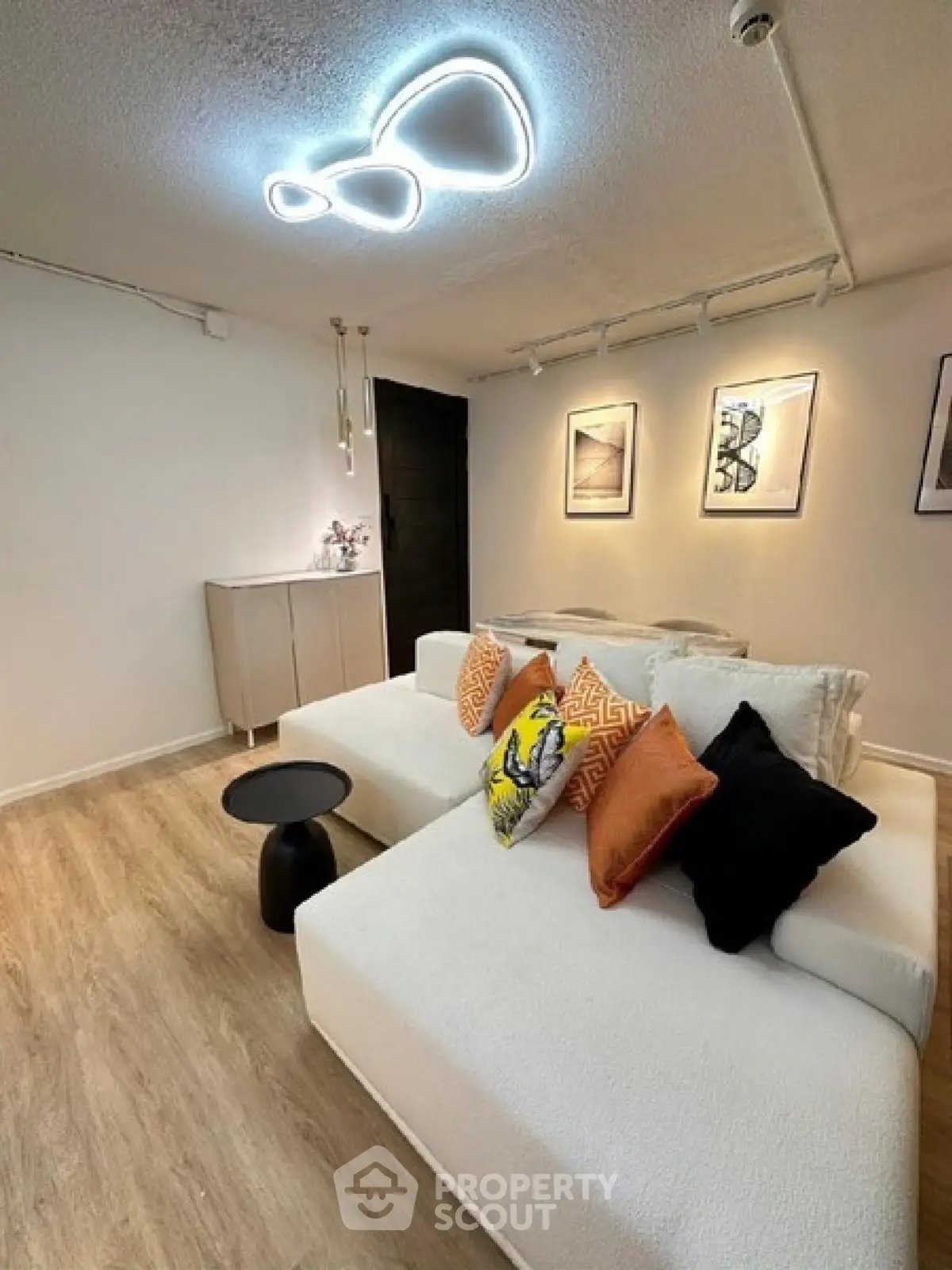 Modern living room with stylish lighting and cozy white sofa
