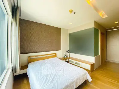 Spacious and bright bedroom with modern design and large window view.