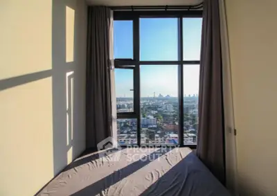 Stunning city view from a modern bedroom with large windows and natural light.