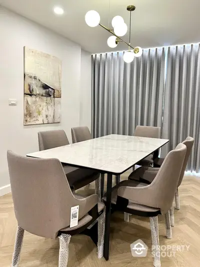 Elegant dining room with modern chandelier and stylish furniture