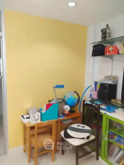Cozy study room with colorful decor and ample storage space, perfect for productivity and creativity.