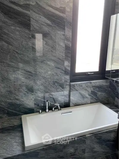 Luxurious bathroom with elegant marble walls and modern bathtub design