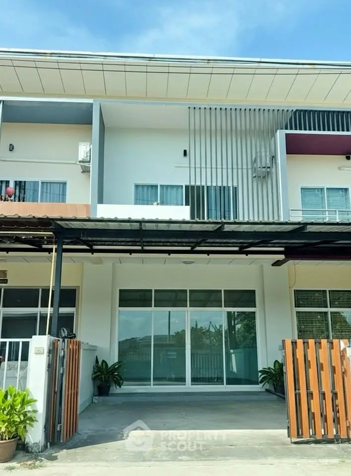 Modern townhouse exterior with sleek design and spacious driveway