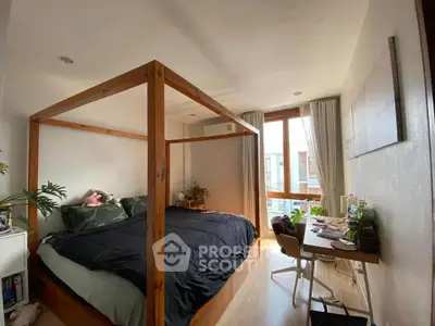 Charming bedroom with four-poster bed and natural light, perfect for cozy living.