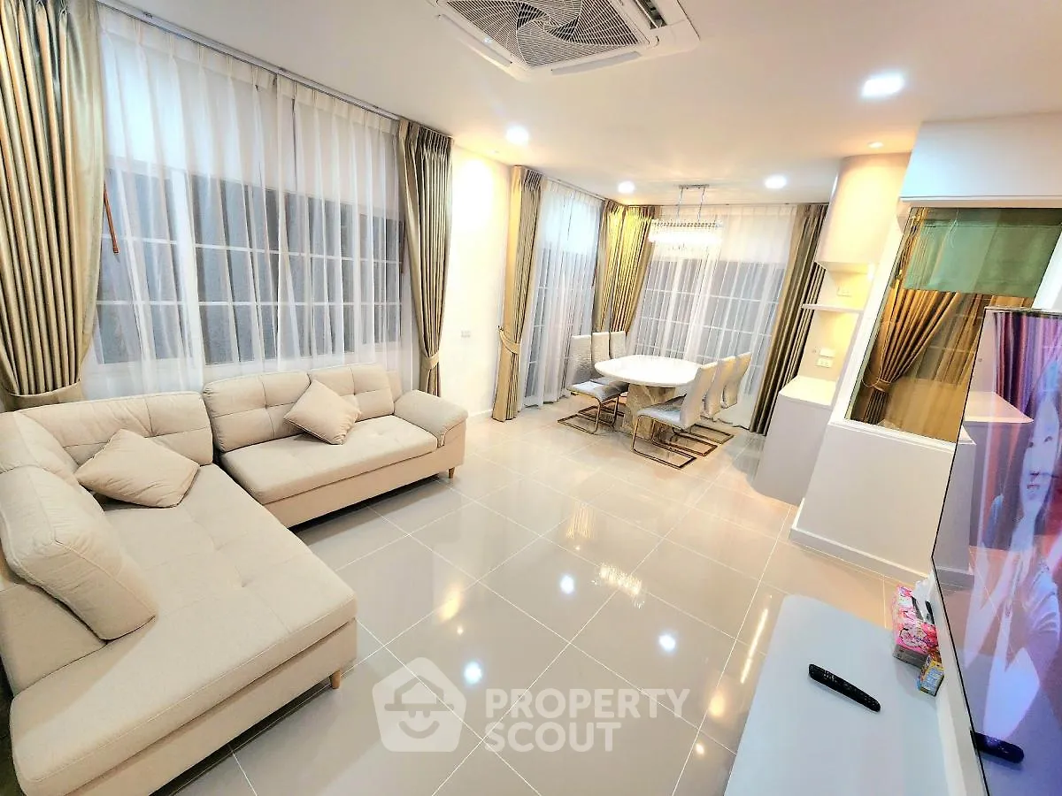 Spacious modern living room with elegant decor and large windows
