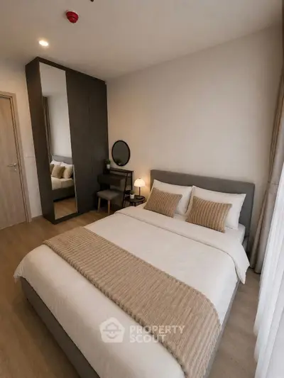 Modern bedroom with cozy decor and stylish furniture in a contemporary apartment.