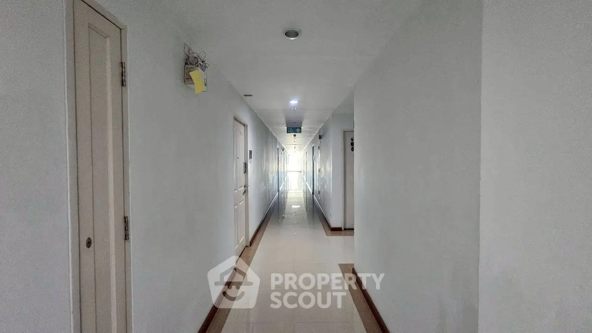 Spacious and well-lit apartment hallway with modern design and clean lines.