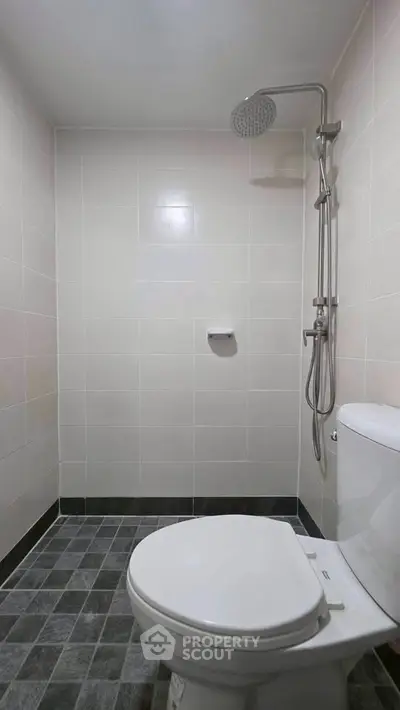 Modern bathroom with sleek shower and tiled walls