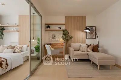 Modern living room with cozy sofa and stylish decor adjacent to a bedroom.