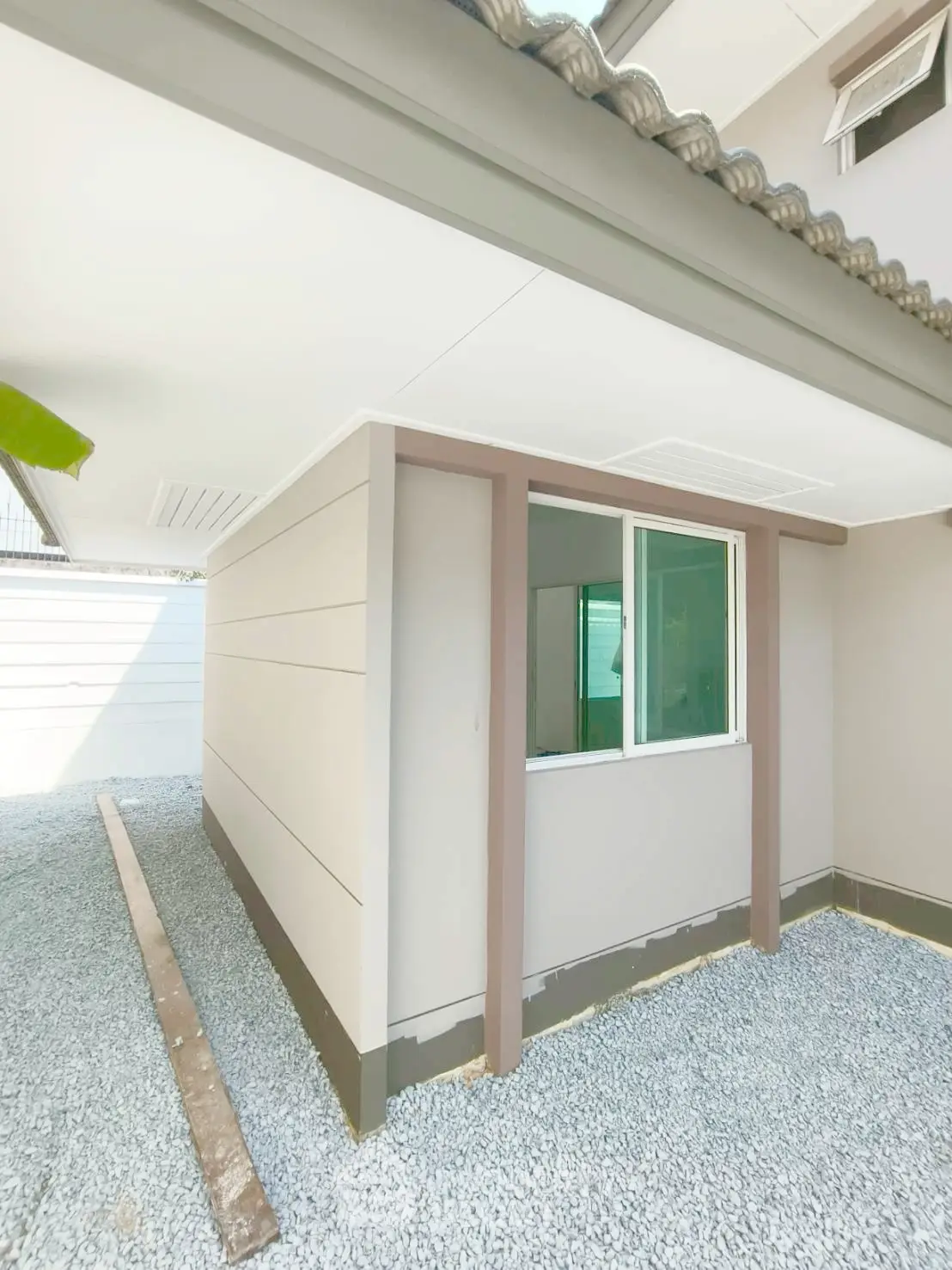 Modern exterior corner unit with sleek design and gravel pathway