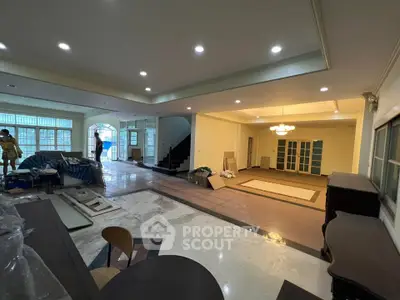 Spacious living room with modern lighting and open layout, ideal for family gatherings.