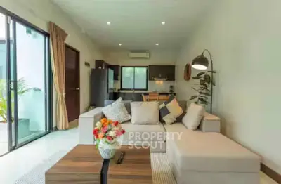 Spacious living room with modern decor and open kitchen layout