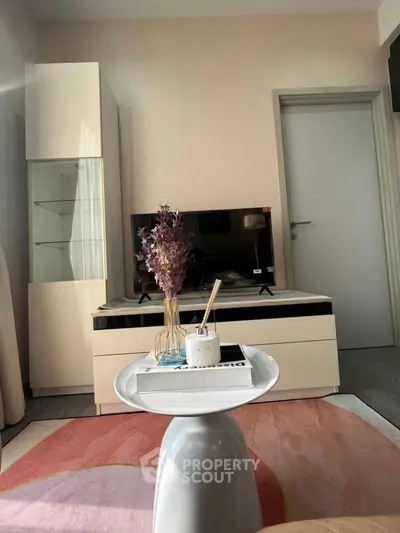 Modern living room with stylish decor and flat-screen TV