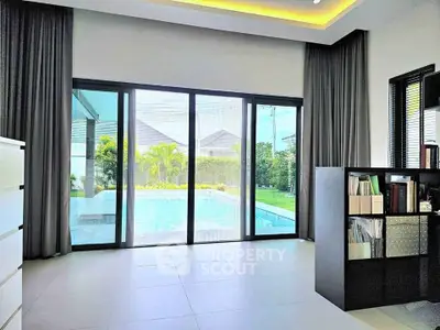Luxurious living room with pool view and modern decor