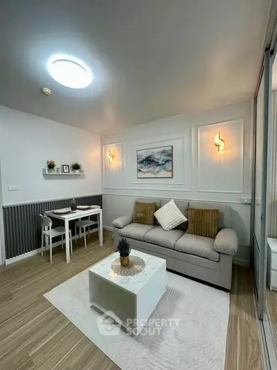 Modern living room with stylish decor, cozy sofa, and elegant lighting in a chic apartment.