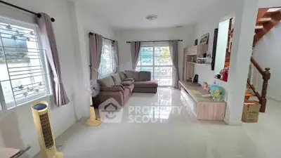 Spacious living room with modern decor and natural light