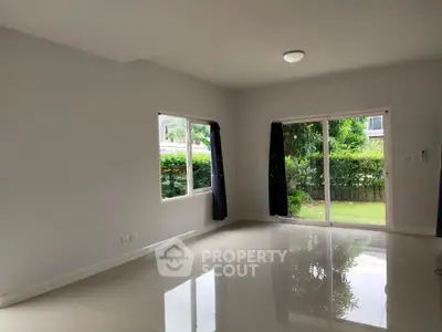 Spacious living room with garden view and large windows