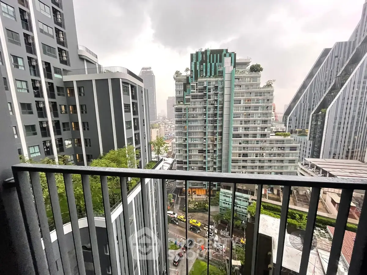Stunning urban view from a high-rise balcony showcasing modern architecture and cityscape.