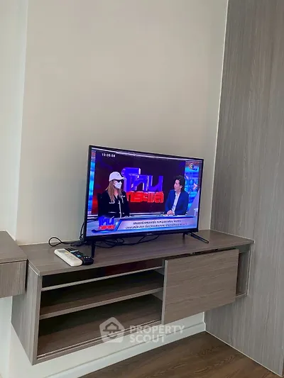 Modern living room with sleek TV setup and stylish wooden cabinet