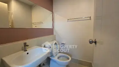 Modern bathroom with sleek fixtures and large mirror