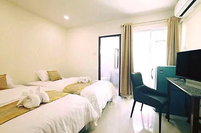 Bright and cozy bedroom with twin beds, modern decor, and natural light.
