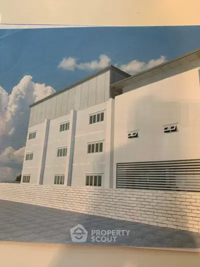 Modern architectural building exterior with sleek design and large windows under a clear blue sky.