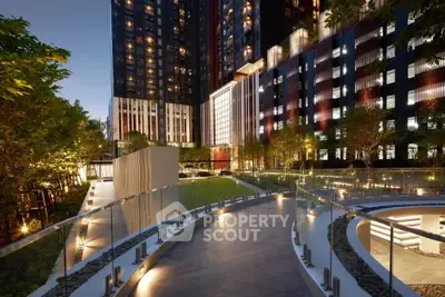 Luxurious modern building exterior with elegant lighting and lush greenery.