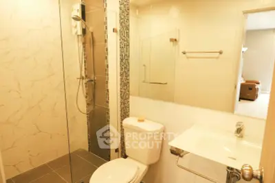 Modern bathroom with glass shower and sleek fixtures in a stylish apartment.