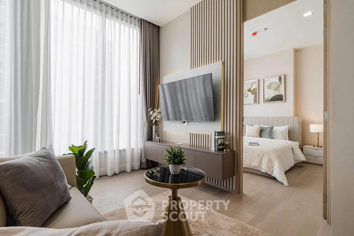 Modern living room with stylish decor and view into elegant bedroom