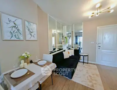 Stylish living room with modern decor, mirrored wall, and cozy dining area in a contemporary apartment.