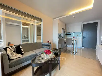 Modern living room with stylish furniture and open kitchen layout in a contemporary apartment.