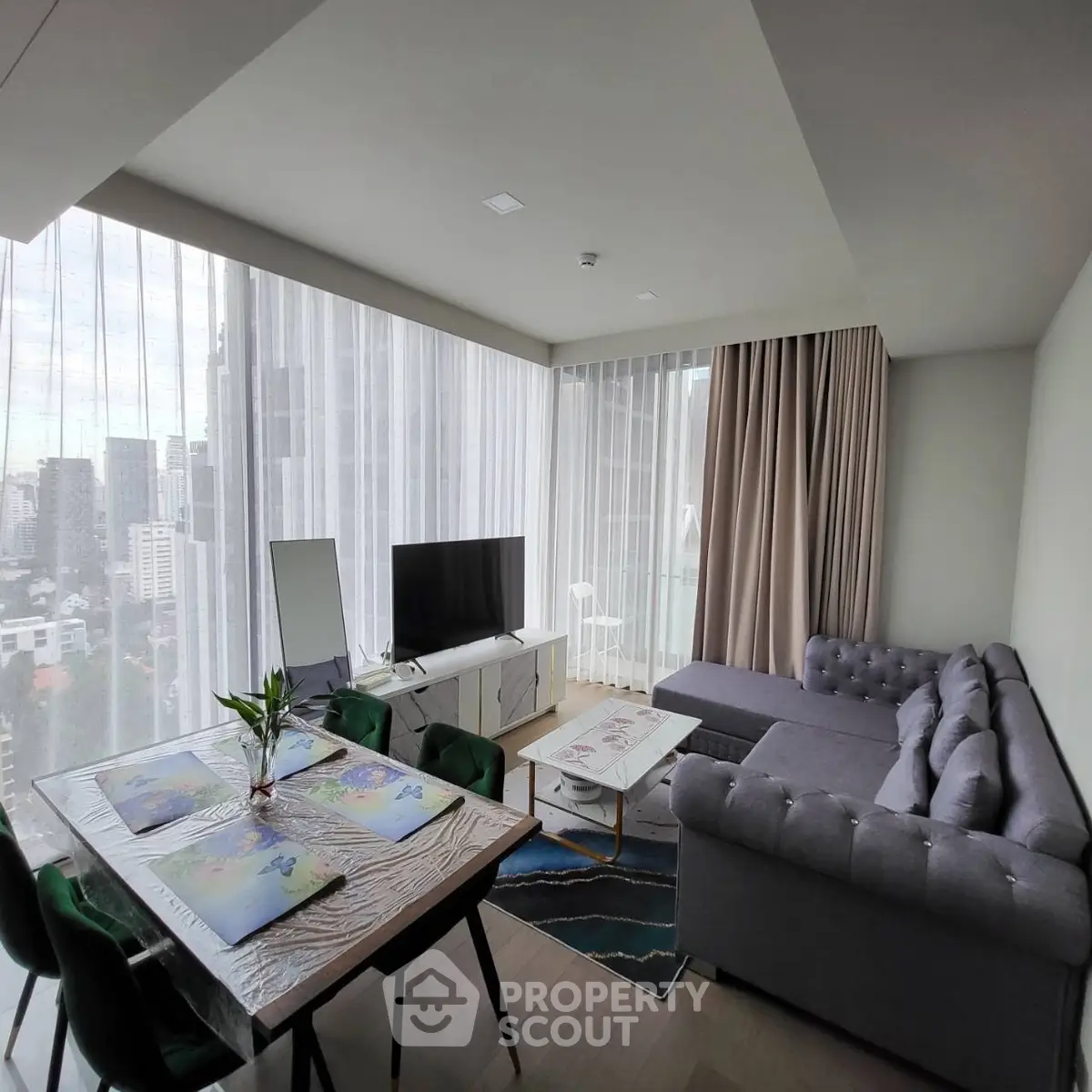 Modern living room with city view, stylish furniture, and natural light